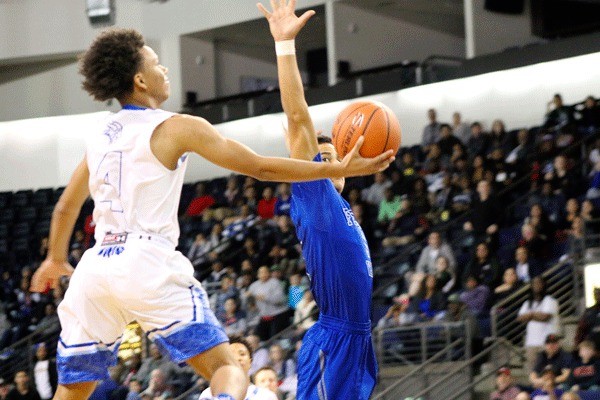 D'Jimon Jones blocks Glenn Jordan's final shot attempt as time expires during Federal Way's 63-61 win over Curtis for the SPSL Championship on at the ShoWare Center in Kent on Feb. 4.