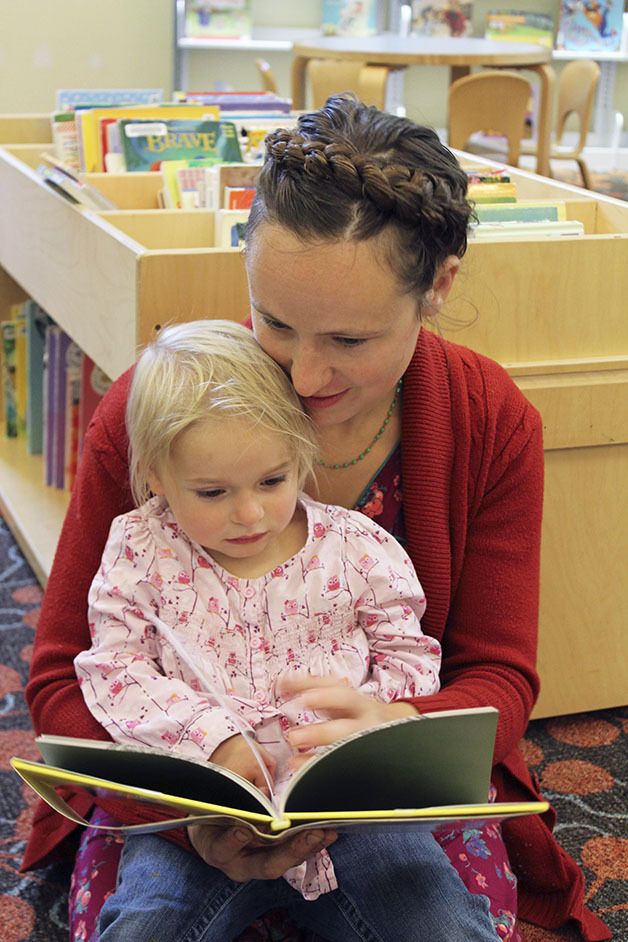 Maria Breneman reads to daughter