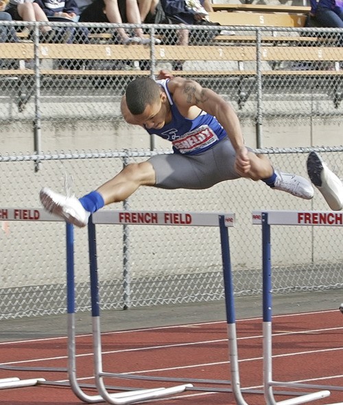 Federal Way senior Robert Shelby clears a hurdle during the SPSL Track and Field Championships at French Field in Kent. Shelby ran a state-best time to win the 300-meter hurdles Friday. The West Central District Meet will be held Friday and Saturday at Mount Tahoma High School.