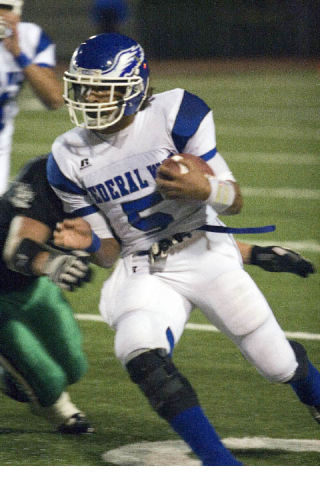 Federal Way senior running back Andre Barrington carries the ball Friday night during a 24-7 loss to the Kentwood Conquerors Friday night at French Field in Kent. Barrington finished with 107 yards.