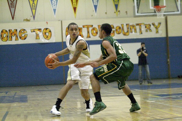 Decatur junior guard Markus Rawls keeps the ball away from a Foss defender during the Gators’ 77-68 loss Friday in the non-league game in Federal Way.