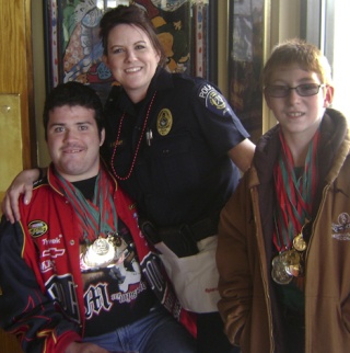 Federal Way police officer Stacy Eckert and Special Olympics Washington athletes Cory Dempsey