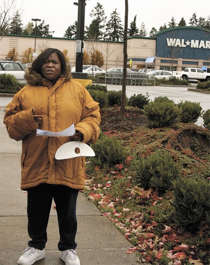 Former Federal Way Wal-Mart employee Kim Quartimon took part in a Walmart Workers for Change event Oct. 26. She expressed her desire to see the corporate company provide more affordable health coverage to its employees. Quartimon and others asked the store's management to 'take off their masks' and help out employees.