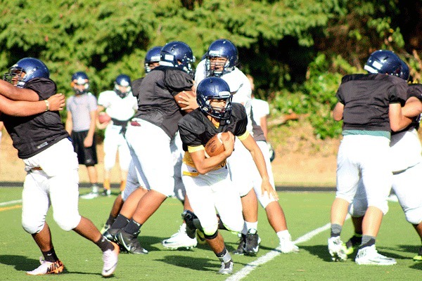 Decatur High School players run a play during a full padded practice on Monday. Decatur finished last year with a 1-9 record and is looking to improve this season.