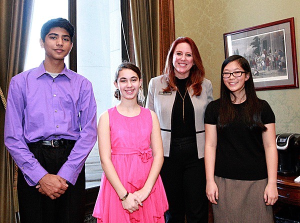 Secretary Kim Wyman with three of the World War II writing contest winners (from left)