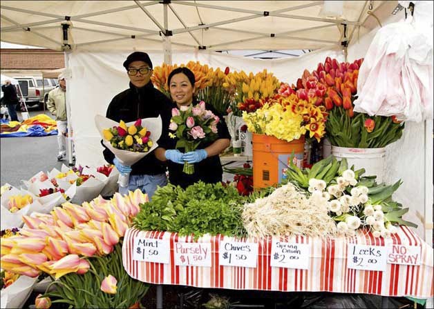 The Federal Way Farmers Market features vendors such as Lee's Family flowers and vegetables.