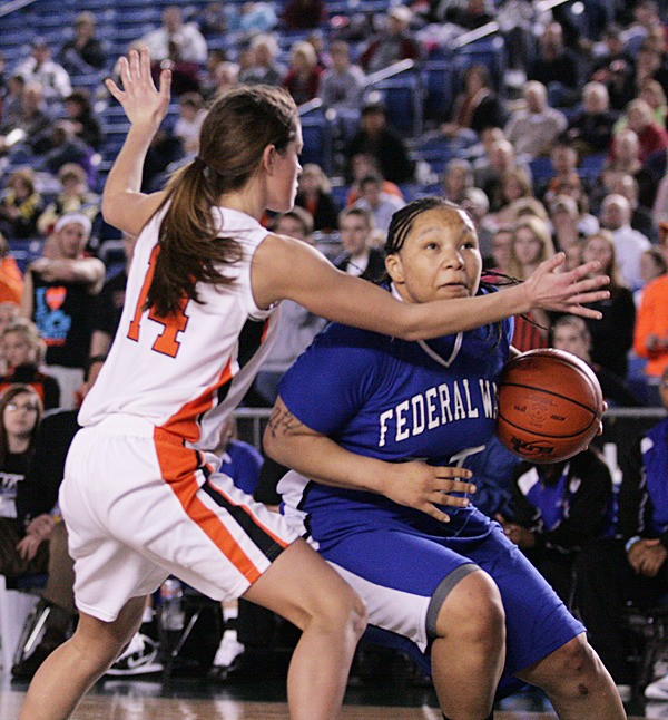 Federal Way senior Brittany Barrington dribbles past Lewis & Clark's Devyn Galland during the state title game Saturday in Tacoma. Barrington was named first-team