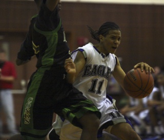 Federal Way senior point guard Michael Hale dribbles past a Kentwood defender Tuesday night during the Eagles' 65-58 win over the Conquerors in an SPSL tiebreaker game at Auburn High. Hale finished with 19 points for the No. 1-ranked Eagles