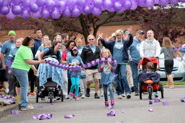 A group of runners 'break the chains' of human trafficking during the Federal Way Coalition Against Trafficking's third annual 5k fundraiser at the Federal Way Farmers Market on Saturday.