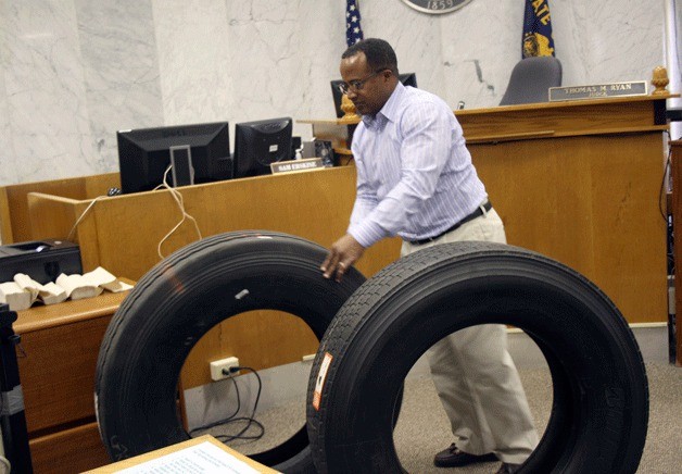 Former Federal Way school board member Tony Moore rolls tires through a Multnomah County courtroom in April. Moore was convicted of seven counts of felony theft and his sentencing was delayed until September.