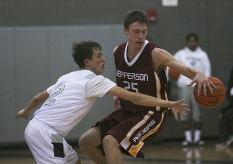 Jefferson senior forward Eric Radford dribbles away from Beamer junior Max Aficiuc during the Raiders' 66-56 win over the third-ranked Titans Monday at Beamer. It was both teams' season openers.