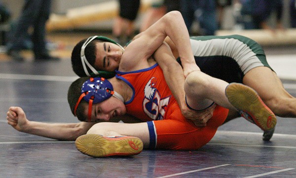 Todd Beamer High School junior Tre Uson (top) takes control of a match Wednesday night against Graham-Kapowsin’s Taylor Salzberg. The Titans beat Federal Way in a dual meet and lost to Graham-Kapowsin in SPSL South action.