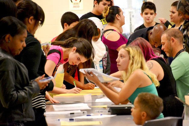 Saghalie Middle School students sign up for athletic teams and activity clubs during the school's annual welcome back barbecue on Friday.