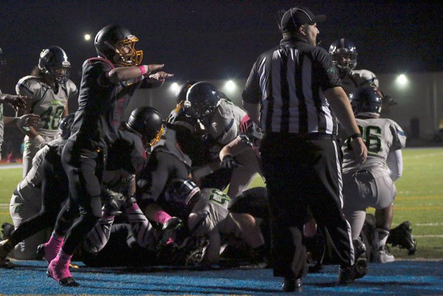 Thomas Jefferson's Mason Delacruz signals that Todd Beamer did not get into the endzone on fourth-and-goal from the one-yard line during the second quarter of Jefferson's 8-0 win on Oct. 9 at Federal Way Memorial Stadium.