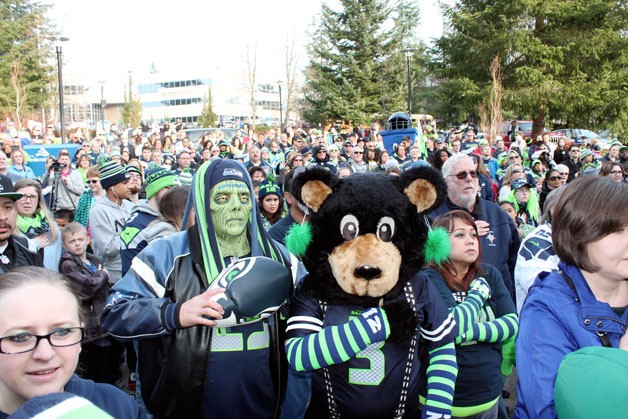 Seahawks fans recite the Pledge of Allegiance during a rally at Federal Way City Hall on Friday.