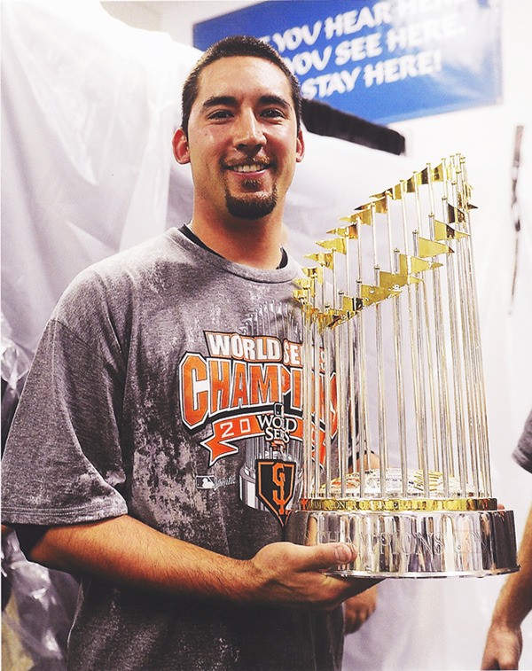 Federal Way High School graduate Travis Ishikawa holds the World Series trophy after helping the San Francisco Giants win the 2010 championship. Ishikawa earned the final roster spot on the Milwaukee Brewers Wednesday.