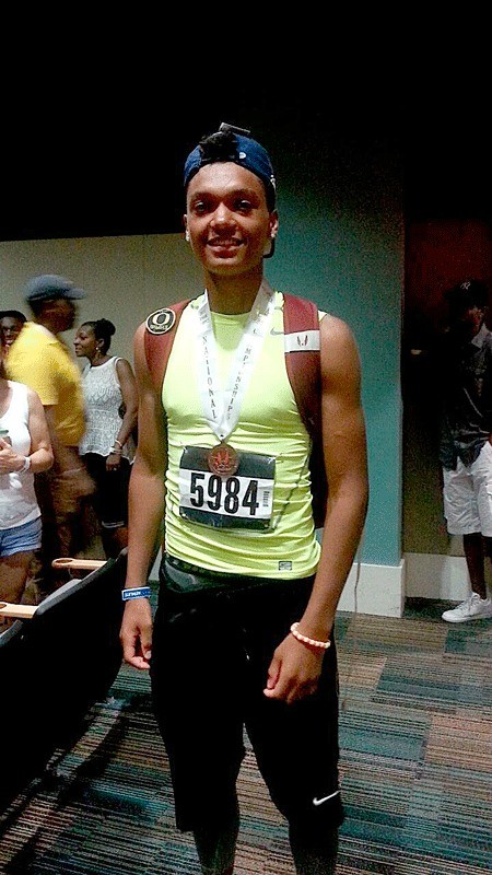 Mason Sallee poses with his medal after finishing third at the USA Track and Field Junior Olympics. Sallee jumped a distance of 47-7 in the triple jump event.