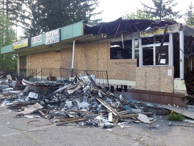 A burned building along Pacific Highway South once housed several businesses before a fire destroyed it in October. The city will soon demolish the building