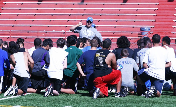 Federal Way High School football coach John Meagher talks to his Eagles team during their first practice of the season Wednesday afternoon at Federal Way Memorial Field. Federal Way opens up on Sept. 2 at Graham-Kapowsin.