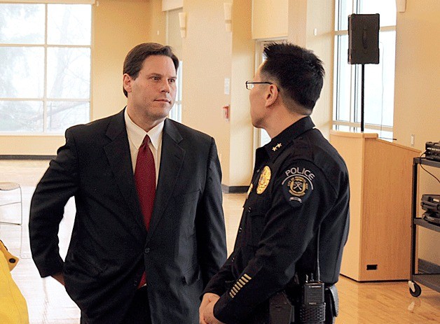 Mayor Jim Ferrell speaks with Deputy Police Chief Andy Hwang during a staff meeting on Monday.