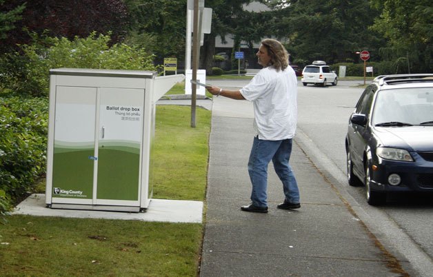 A voter drops off a ballot Tuesday evening near City Hall in Federal Way.