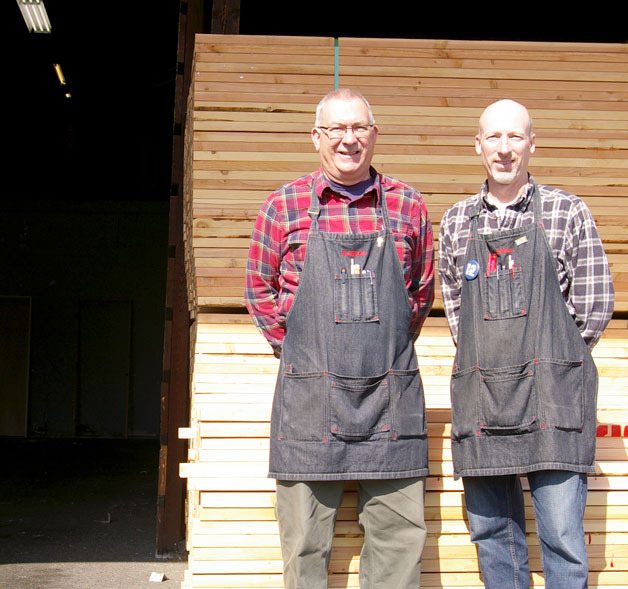 New Lumber and Hardware co-owners Jim (left) and Bill Eichholtz pose for a photo in the lumber yard of their store