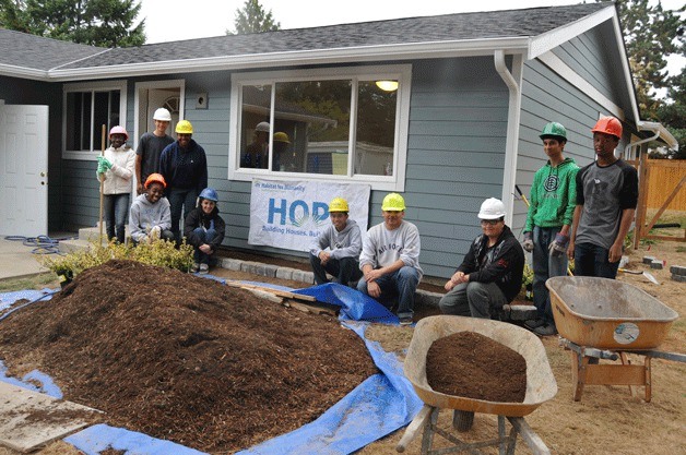 Federal Way High School students volunteer for a recent Habitat for Humanity project as part of the school's United States Air Force Junior Reserve Officer Training Corps (JROTC) program. The program is also offered at Todd Beamer High School.