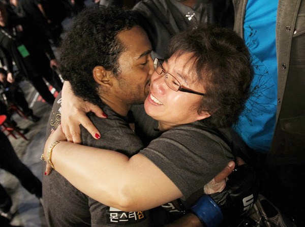 Decatur graduate Benson Henderson hugs his mother