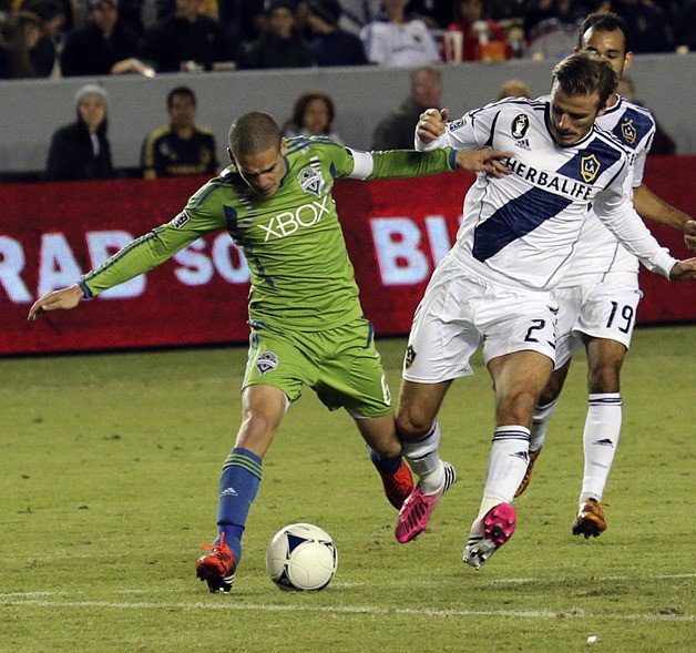 Osvaldo Alonso of the Seattle Sounders battles for the ball against David Beckham of the LA Galaxy during Sunday's game in Carson