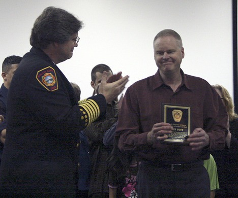 Jeff Pint accepts his award from Chief Al Church for his service in performing CPR on a passenger on his Metro bus Halloween night. Because of his quick action