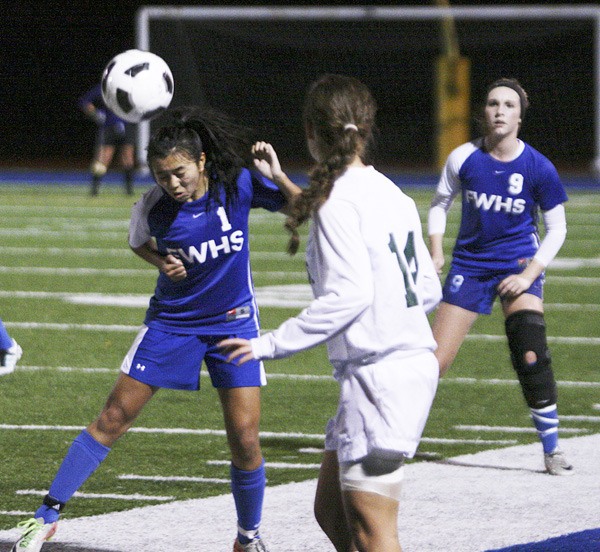 Federal Way junior Jenessa Ho heads the ball during the Eagles' 3-0 win over Kentwood Wednesday at Federal Way Memorial Stadium. The game was between the third-place finishers in the SPSL South and North divisions.