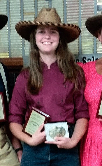 Paige Dasher poses with her awards. She recently won the Single Action Shooting Society Washington and Northwest Regional Championships in her shooting division.