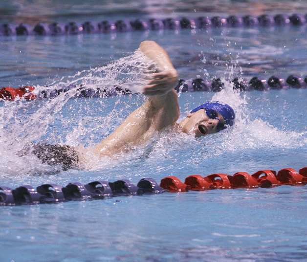 Federal Way High School’s Aaron Persinger swims the freestyle leg of the 200-yard medley relay during Friday’s preliminary round at the Class 4A State Swim Meet in Federal Way.