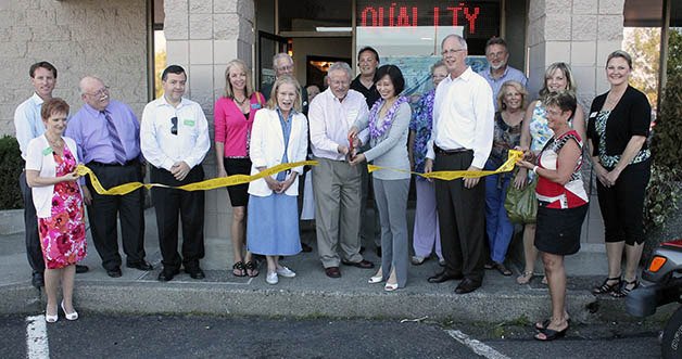 The Federal Way Chamber of Commerce hosted a grand opening and ribbon cutting for Art of Smiles at 1706 S. 320th St. #E.  Dr. Amanda Huang is cutting the ribbon.