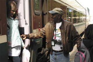 Eugene Montgomery helps passengers get off the train May 12 at the Amtrak station in Tacoma.