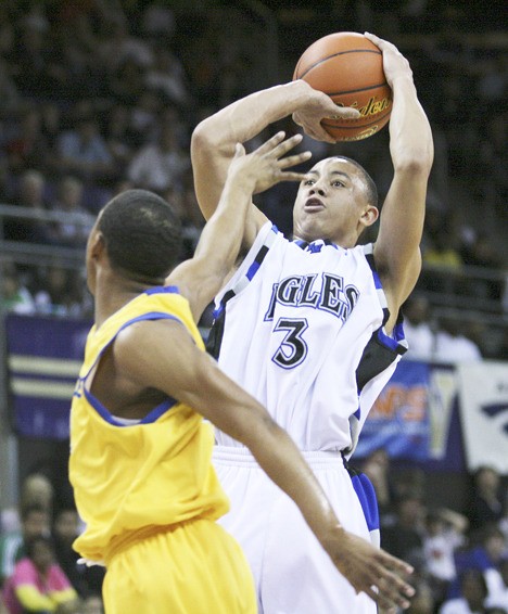 Federal Way senior guard takes a shot over a Jefferson defender during Monday's 62-58 Eagle loss at the King Holiday Hoopfest at the University of Washington. The loss ended Federal Way's 29-game winning streak. Umipig finished with 15 points.