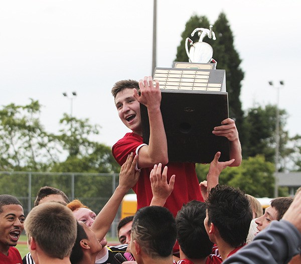 Jefferson senior Rodrigo Robles holds the Class 4A state championship trophy after the Raiders beat Union