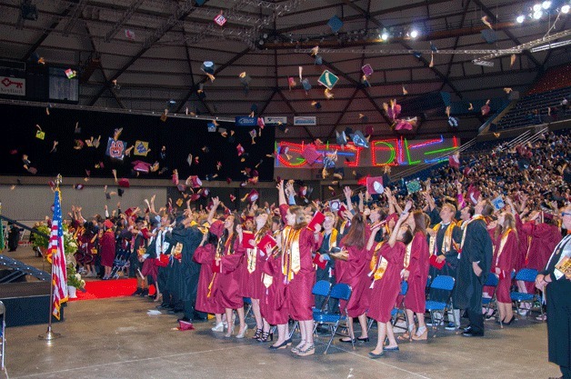 Thomas Jefferson High School seniors throw up their caps during the school's graduation ceremony on June 14 at the Tacoma Dome.