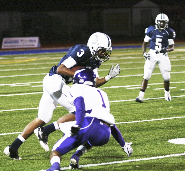 Todd Beamer High School senior Marcus Saddler runs the ball during the Titans’ 28-17 win over the Puyallup Vikings Thursday at Federal Way Memorial Stadium. The win secured the Titans the fourth seed from the SPSL South and the school's first-ever playoff berth.