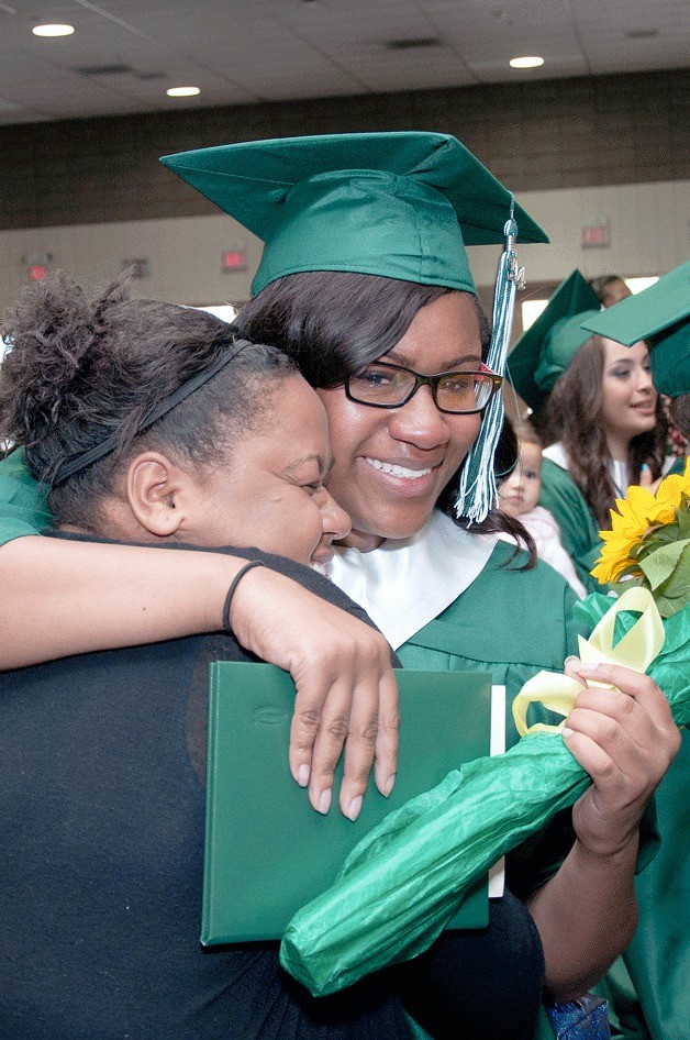 A senior from Career Academy at Truman celebrates with a loved one during the school's commencement ceremony on June 14 at the Tacoma Dome.