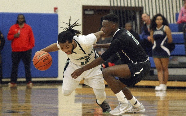 Todd Beamer's Gio Jackson defends against Emerald Ridge's Raeshon Scales during the second half of Beamer's 71-66 loss on Feb. 12 at Stadium High School.