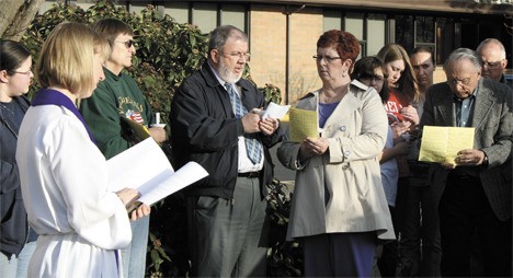 Calvary Lutheran Church parishioner Neal Cook reads Psalm 145 during a candlelight vigil held March 24 for Carol Parsons