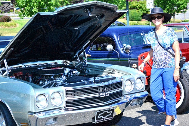 A woman checks out a classic Chevrolet during the 10th annual Lions Scholarship Car Show on Saturday at The Commons mall.