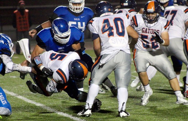 Federal Way's Andrzej Hughes-Murray stuffs Decatur's Denny Toso on a run in the second quarter of Federal Way's 50-12 win on Oct. 2 at Federal Way Memorial Stadium.