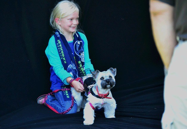 A girl and her pooch pose during a photo shoot at the city's seventh annual K-9 Karnival on Saturday at Celebration Park.