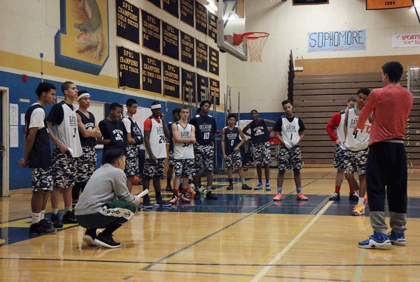 Decatur basketball players gather to listen to their coaches at the end of their practice on Dec. 14 at Decatur High School.