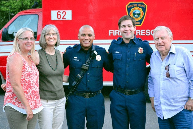 Federal Way police officers stand with community members at one of the neighborhood National Night Out events in Federal Way on Aug. 5.