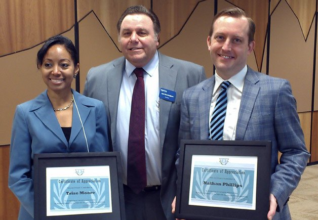 Highline President Jack Bermingham (center) presents Trise Moore (left) and Nathan Phillips (right) with Outstanding Community Partner awards.