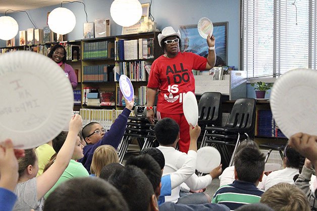 Local author Helen Collier spoke to Lake Dolloff Elementary students on May 15 in the school's library. Students wrote their names on paper plates with the sentence 'I am important.'