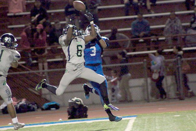 Cameron Quinn leaps in front of Federal Way's Bobi Sims to intercept a pass in the first quarter of Todd Beamer's 16-6 win on Friday